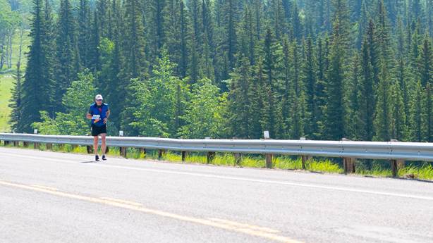 <p>Dr. Michael Hill runs along the highway in the Kananaskis Valley southwest of Calgary.&nbsp;&nbsp;</p>