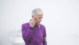 Woman listening to music while exercising outside 
