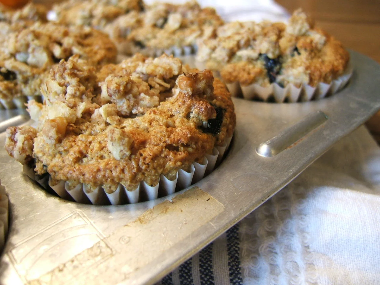 Blueberry oatmeal walnut muffins in a baking tray.