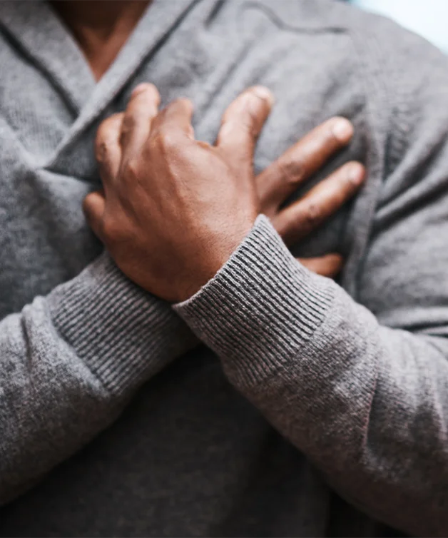 A person holds their chest in pain.